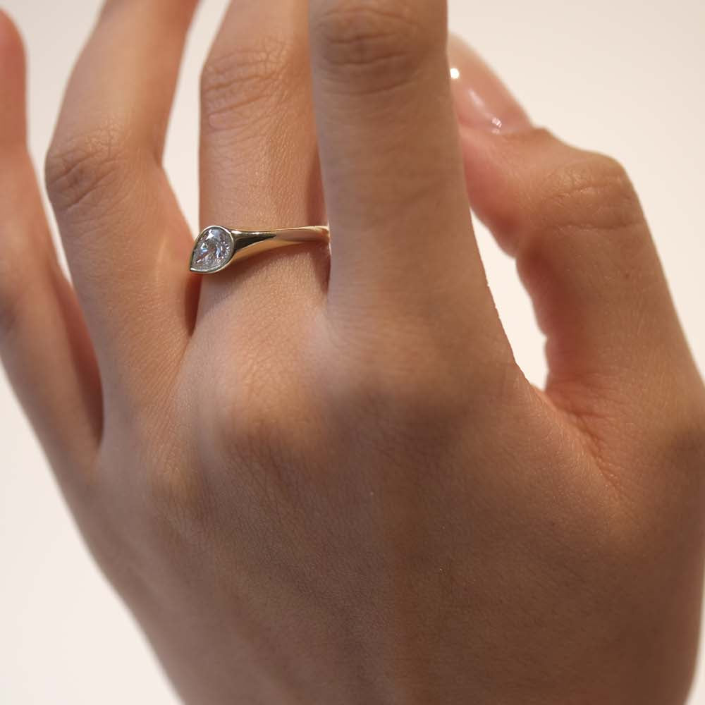 A teardrop-shaped diamond ring that captures natural movement through soft, fluid geometry. The pear-cut diamond blends marquise and oval influences, creating a silhouette that feels both delicate and powerful.
The DIAMOND DROP II is a 14K solid gold Fine Jewelry engagement ring, handcrafted in the Ruby Star studio. It represents contemporary luxury jewelry at its most refined—minimal, organic, and quietly expressive.
Designed as a modern heirloom, this piece balances comfort, elegance, and sculptural clari