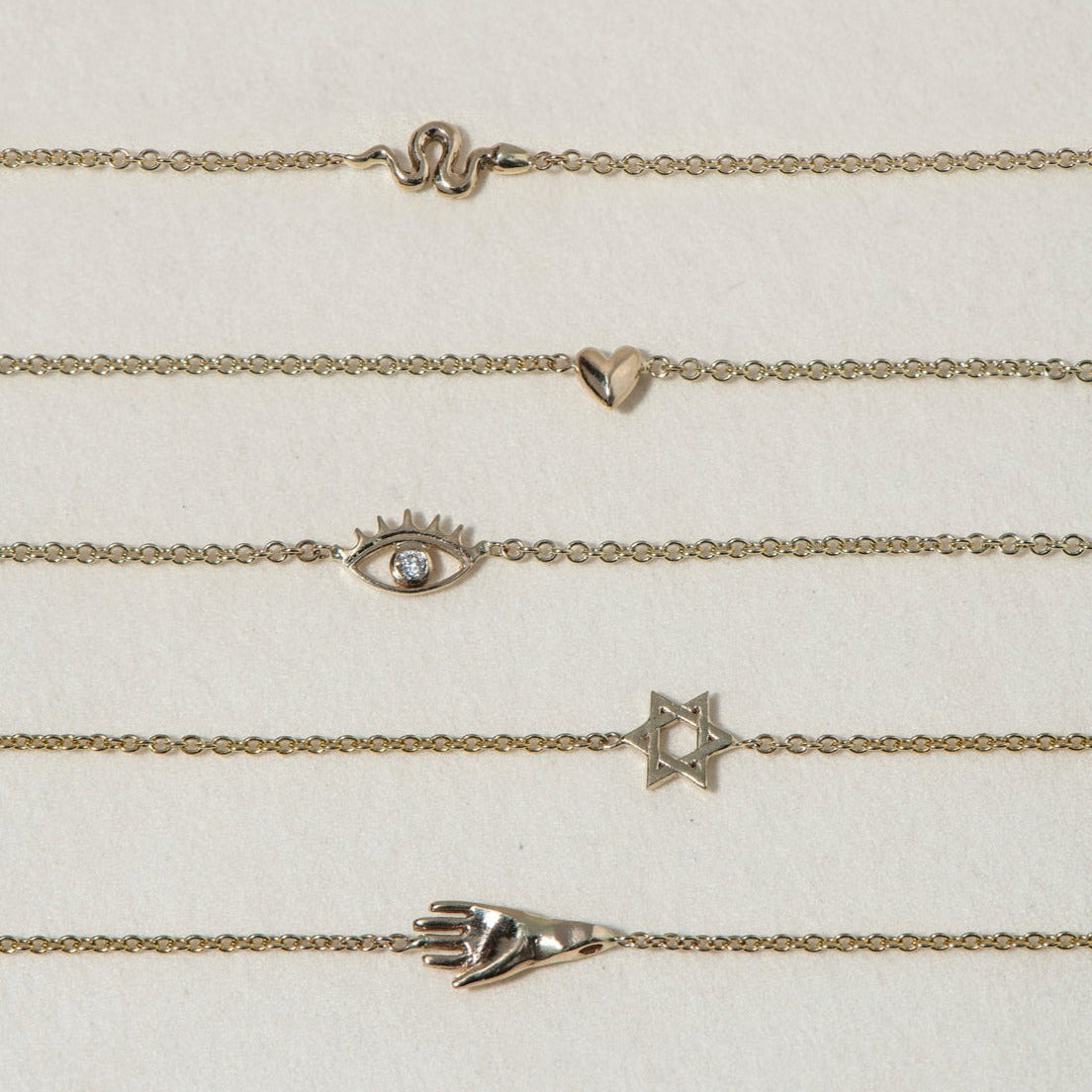 SEO TITLE

Mini Hamsa Bracelet – 14K Gold Protection Bracelet | Ruby Star Studio

META TITLE

Mini Hamsa Bracelet | 14K Gold Hand of God Protection Bracelet | Ruby Star Studio

META DESCRIPTION

A miniature Hamsa bracelet handcrafted in 14K gold. A powerful symbol of protection, strength, peace and good fortune, designed for everyday wear.

MINI HAMSA BRACELET

A protective symbol worn close to the skin.

The Mini Hamsa Bracelet is handcrafted in solid 14K gold and features the iconic Hamsa hand — an ancien