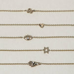 SEO TITLE

Mini Hamsa Bracelet – 14K Gold Protection Bracelet | Ruby Star Studio

META TITLE

Mini Hamsa Bracelet | 14K Gold Hand of God Protection Bracelet | Ruby Star Studio

META DESCRIPTION

A miniature Hamsa bracelet handcrafted in 14K gold. A powerful symbol of protection, strength, peace and good fortune, designed for everyday wear.

MINI HAMSA BRACELET

A protective symbol worn close to the skin.

The Mini Hamsa Bracelet is handcrafted in solid 14K gold and features the iconic Hamsa hand — an ancien