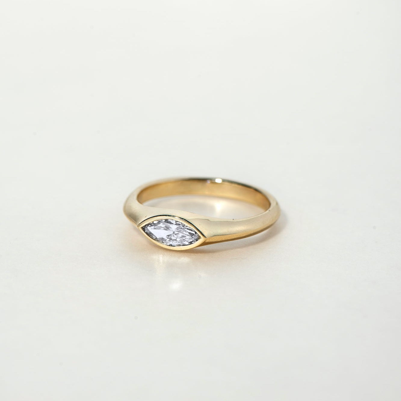 FAY RING
A minimalist signet-style engagement ring where the marquise diamond becomes part of a seamless gold structure.
The FAY RING is a 14K solid gold Fine Jewelry piece that embodies softness, strength, and sculptural clarity.
Handcrafted in the Ruby Star studio as a modern heirloom engagement ring.
Details:
• 0.40ct marquise diamond (natural or lab-grown)
• Bezel setting
• 14K solid gold
• Handmade fine jewelry
• Minimal sculptural design
A luxury engagement ring for those drawn to clean lines and time