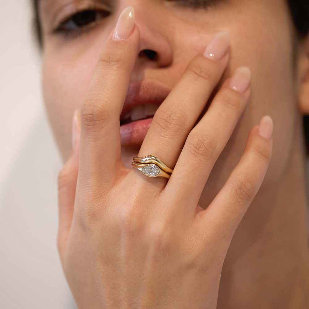 A teardrop-shaped diamond ring that captures natural movement through soft, fluid geometry. The pear-cut diamond blends marquise and oval influences, creating a silhouette that feels both delicate and powerful.
The DIAMOND DROP II is a 14K solid gold Fine Jewelry engagement ring, handcrafted in the Ruby Star studio. It represents contemporary luxury jewelry at its most refined—minimal, organic, and quietly expressive.
Designed as a modern heirloom, this piece balances comfort, elegance, and sculptural clari