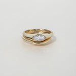 FAY RING
A minimalist signet-style engagement ring where the marquise diamond becomes part of a seamless gold structure.
The FAY RING is a 14K solid gold Fine Jewelry piece that embodies softness, strength, and sculptural clarity.
Handcrafted in the Ruby Star studio as a modern heirloom engagement ring.
Details:
• 0.40ct marquise diamond (natural or lab-grown)
• Bezel setting
• 14K solid gold
• Handmade fine jewelry
• Minimal sculptural design
A luxury engagement ring for those drawn to clean lines and time