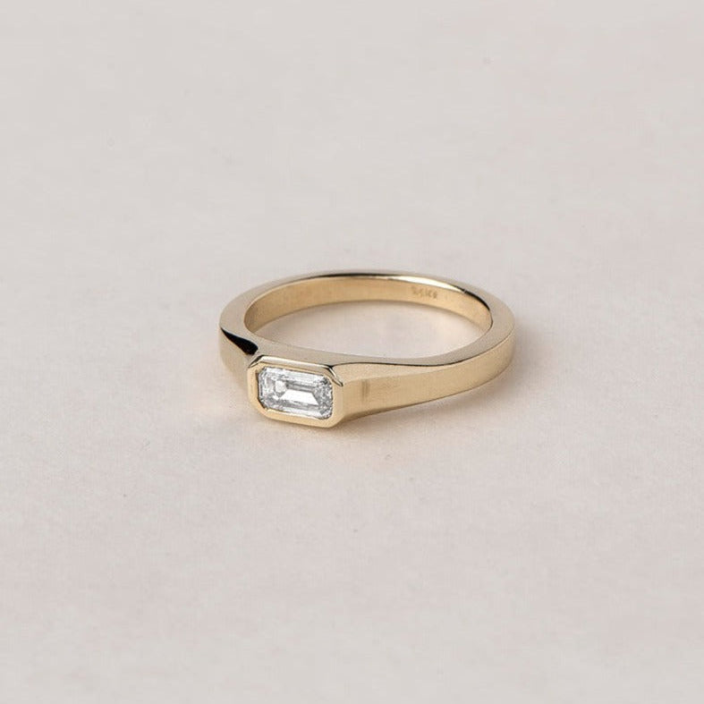 ARISE RING
An Art Deco-inspired architectural engagement ring where geometry and elegance merge. The emerald-cut diamond is framed with precision and clarity.
The ARISE RING is a 14K solid gold Fine Jewelry engagement ring designed with sculptural restraint and timeless sophistication.
Handcrafted in the Ruby Star studio as a modern heirloom.
Details:
• 0.45ct emerald-cut diamond
• Architectural bezel setting
• 14K solid gold
• Handmade fine jewelry
• Art Deco influence
A luxury emerald-cut engagement ring 