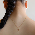 A miniature snake necklace handcrafted in 14K solid gold, suspended from a delicate curb chain. Small in scale yet rich in symbolism, it balances sculptural simplicity with quiet presence.

Throughout history, snakes have symbolized fertility, creative life force, and renewal. As snakes shed their skin to survive, they remind us of the importance of releasing what no longer serves us in order to grow and transform. They are enduring symbols of rebirth, healing, and personal evolution.

The MINI SNAKE NECKLA