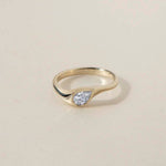 DIAMOND DROP I
A teardrop diamond ring with a softer architectural presence, where bezel setting and organic lines merge into a fluid silhouette.
The DIAMOND DROP I is a 14K solid gold Fine Jewelry engagement ring designed with quiet strength and modern elegance.
Handcrafted in the Ruby Star studio as a modern heirloom piece.
Details:
• 0.50ct pear-shaped diamond (natural or lab-grown F VS)
• Bezel setting
• 14K solid gold
• Handmade fine jewelry
• Organic sculptural design
A luxury pear-cut engagement ring