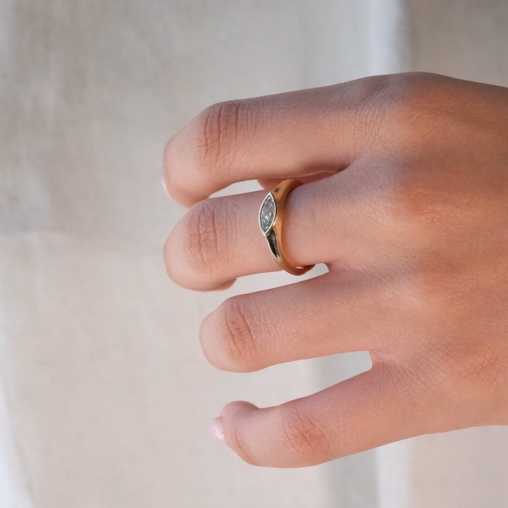 FAY RING
A minimalist signet-style engagement ring where the marquise diamond becomes part of a seamless gold structure.
The FAY RING is a 14K solid gold Fine Jewelry piece that embodies softness, strength, and sculptural clarity.
Handcrafted in the Ruby Star studio as a modern heirloom engagement ring.
Details:
• 0.40ct marquise diamond (natural or lab-grown)
• Bezel setting
• 14K solid gold
• Handmade fine jewelry
• Minimal sculptural design
A luxury engagement ring for those drawn to clean lines and time