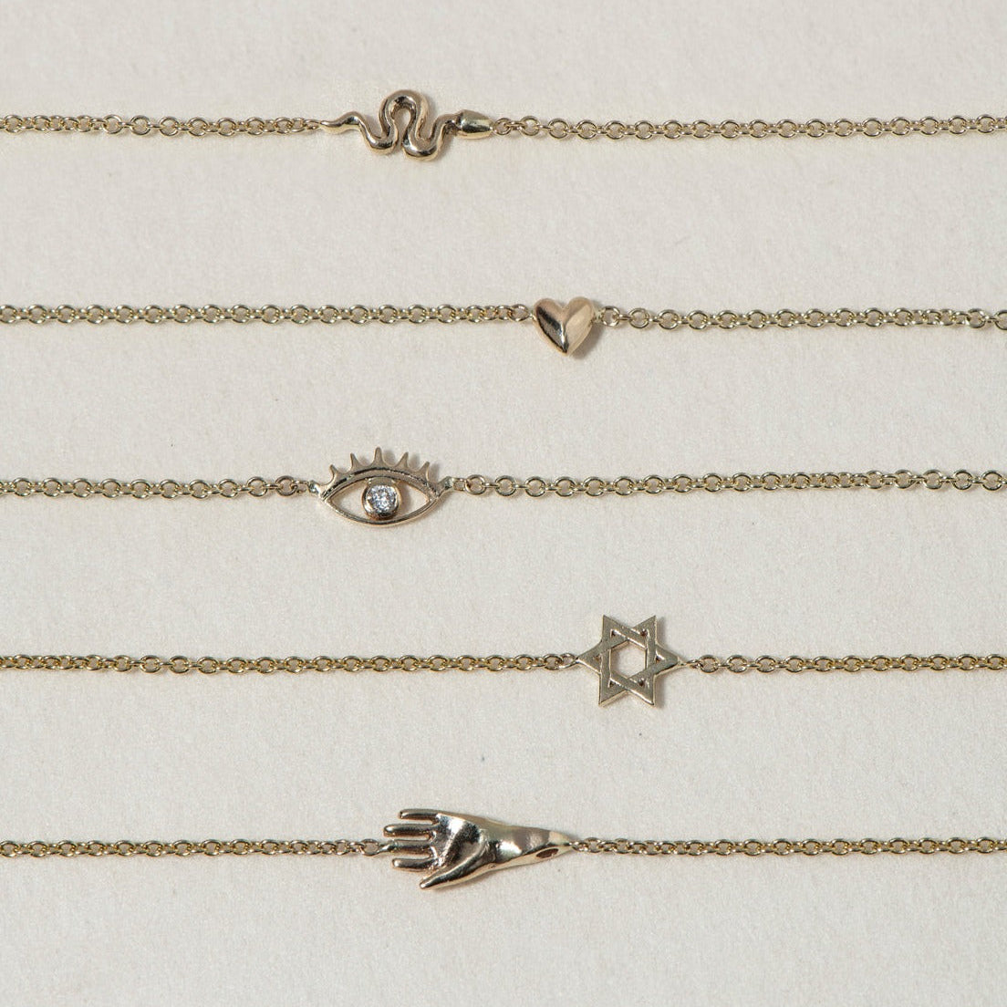 A miniature snake bracelet handcrafted in 14K solid gold. Delicate yet symbolic, it is a quiet expression of transformation, balancing sculptural simplicity with meaningful design.

Throughout history, snakes have represented fertility, creative life force, and renewal. As snakes shed their skin to survive, they remind us of our own ability to release, evolve, and begin again. They are enduring symbols of healing, rebirth, and personal transformation.

The MINI SNAKE BRACELET is a handcrafted Fine Jewelry p