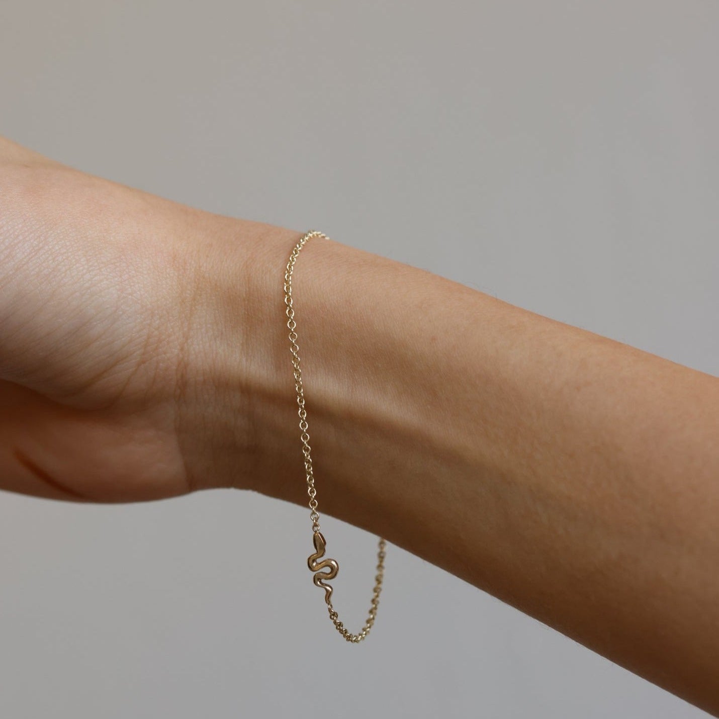 A miniature snake bracelet handcrafted in 14K solid gold. Delicate yet symbolic, it is a quiet expression of transformation, balancing sculptural simplicity with meaningful design.

Throughout history, snakes have represented fertility, creative life force, and renewal. As snakes shed their skin to survive, they remind us of our own ability to release, evolve, and begin again. They are enduring symbols of healing, rebirth, and personal transformation.

The MINI SNAKE BRACELET is a handcrafted Fine Jewelry p