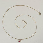 MINI EYE NECKLACE
English

A miniature eye necklace handcrafted in 14K solid gold and suspended from a delicate curb chain. Small in scale yet rich in meaning, it is a quiet symbolic object that balances sculptural simplicity with a sense of protection and inner awareness.

The symbolism of the eye has existed for thousands of years and has always been associated with consciousness and perception. The Evil Eye is worn for protection, the All-Seeing Eye represents divine providence, and the Third Eye symboli