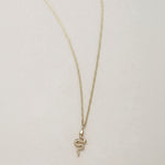 A miniature snake necklace handcrafted in 14K solid gold, suspended from a delicate curb chain. Small in scale yet rich in symbolism, it balances sculptural simplicity with quiet presence.

Throughout history, snakes have symbolized fertility, creative life force, and renewal. As snakes shed their skin to survive, they remind us of the importance of releasing what no longer serves us in order to grow and transform. They are enduring symbols of rebirth, healing, and personal evolution.

The MINI SNAKE NECKLA