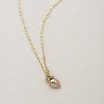 MINI VASE NECKLACE
English

A miniature vessel necklace handcrafted in 14K solid gold and suspended from a delicate curb chain. Small in scale yet rich in symbolism, it is a sculptural object that balances softness, femininity, and quiet presence.

Throughout history, the vessel has been a feminine, mystical, and ceremonial symbol. In biblical tradition, a vessel represents a person chosen to carry purpose and meaning. At its essence, the vessel symbolizes the human body—particularly the female body that ho