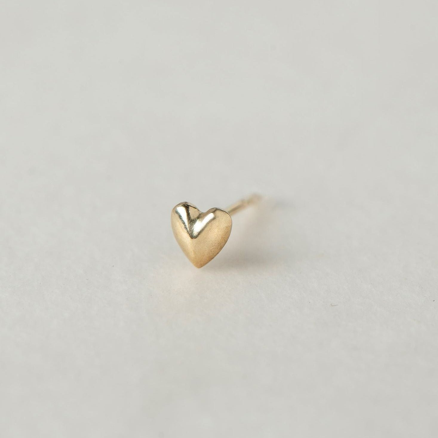 SEO TITLE

Mini Heart Stud – 14K Gold Heart Earring | Ruby Star Studio

META TITLE

Mini Heart Stud | 14K Gold Symbolic Earring | Ruby Star Studio

META DESCRIPTION

A miniature 14K gold heart stud symbolizing love, compassion and emotional wisdom. Handcrafted fine jewelry designed for everyday wear.

MINI HEART STUD

A tiny heart with enduring meaning.

The Mini Heart Stud is handcrafted in solid 14K gold and designed as a delicate everyday talisman. Measuring just 5.5 mm, this miniature heart carries one 