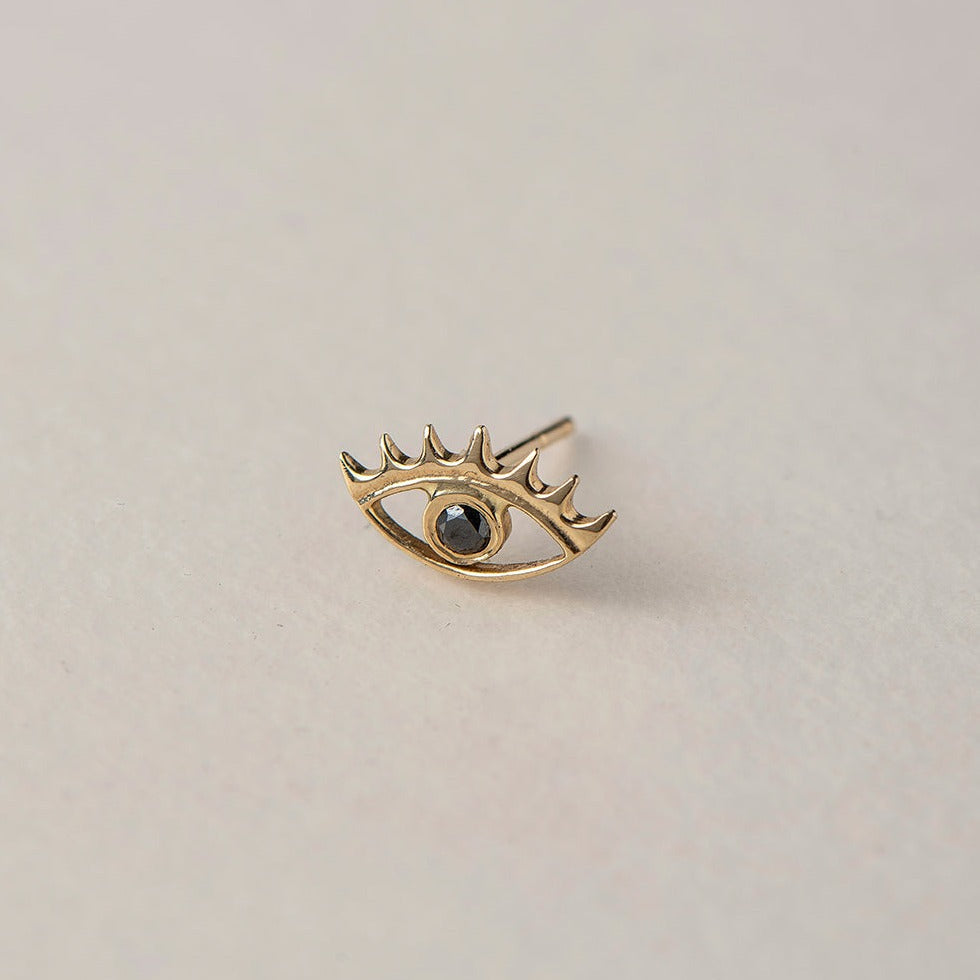 A miniature eye crafted in 14K solid gold. Delicate in scale yet rich in symbolism, it is a quiet object that bridges the visible and the unseen, balancing sculptural simplicity with meaningful design.

The symbolism of the eye has existed for thousands of years and is deeply associated with consciousness and awareness. The Evil Eye is worn for protection, the All-Seeing Eye represents divine providence, and the Third Eye symbolizes intuition, inner wisdom, and enlightenment.

The eye is a bridge between th