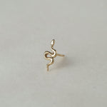 MINI SNAKE STUD

A miniature snake crafted in 14K solid gold. A small symbolic object with a quiet presence, balancing sculptural simplicity with profound meaning.

Historically, snakes have represented fertility, creative life force, and renewal. As snakes shed their skin in order to survive, they remind us of the importance of releasing what no longer serves us so that we may grow and transform.

The MINI SNAKE STUD is a handcrafted Fine Jewelry piece, created in the Ruby Star studio by local artisans. It