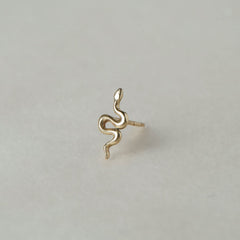 MINI SNAKE STUD

A miniature snake crafted in 14K solid gold. A small symbolic object with a quiet presence, balancing sculptural simplicity with profound meaning.

Historically, snakes have represented fertility, creative life force, and renewal. As snakes shed their skin in order to survive, they remind us of the importance of releasing what no longer serves us so that we may grow and transform.

The MINI SNAKE STUD is a handcrafted Fine Jewelry piece, created in the Ruby Star studio by local artisans. It