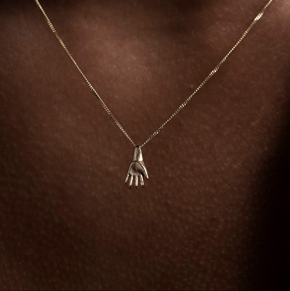 SEO TITLE

Mini Hand Necklace – 14K Gold Hamsa Necklace | Ruby Star Studio

META TITLE

Mini Hand Necklace | 14K Gold Hamsa Protection Necklace | Ruby Star Studio

META DESCRIPTION

A miniature Hamsa hand necklace handcrafted in 14K gold. A symbol of protection, strength, peace, generosity and good fortune. Fine jewelry by Ruby Star Studio.

MINI HAND NECKLACE

A timeless symbol of protection and blessing.

The Mini Hand Necklace is handcrafted in solid 14K gold and inspired by the ancient Hamsa — one of th