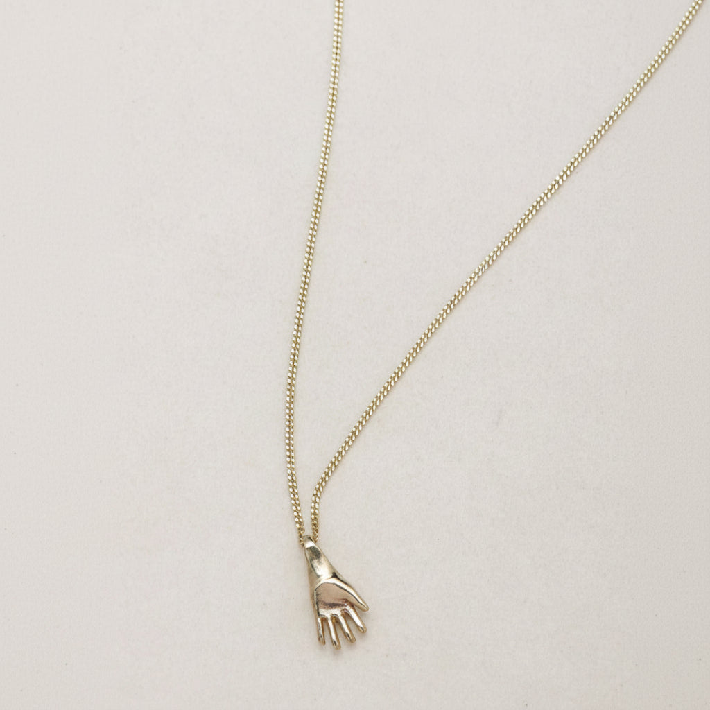 SEO TITLE

Mini Hand Necklace – 14K Gold Hamsa Necklace | Ruby Star Studio

META TITLE

Mini Hand Necklace | 14K Gold Hamsa Protection Necklace | Ruby Star Studio

META DESCRIPTION

A miniature Hamsa hand necklace handcrafted in 14K gold. A symbol of protection, strength, peace, generosity and good fortune. Fine jewelry by Ruby Star Studio.

MINI HAND NECKLACE

A timeless symbol of protection and blessing.

The Mini Hand Necklace is handcrafted in solid 14K gold and inspired by the ancient Hamsa — one of th