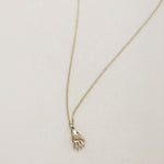 SEO TITLE

Mini Hand Necklace – 14K Gold Hamsa Necklace | Ruby Star Studio

META TITLE

Mini Hand Necklace | 14K Gold Hamsa Protection Necklace | Ruby Star Studio

META DESCRIPTION

A miniature Hamsa hand necklace handcrafted in 14K gold. A symbol of protection, strength, peace, generosity and good fortune. Fine jewelry by Ruby Star Studio.

MINI HAND NECKLACE

A timeless symbol of protection and blessing.

The Mini Hand Necklace is handcrafted in solid 14K gold and inspired by the ancient Hamsa — one of th
