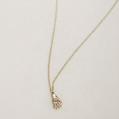 SEO TITLE

Mini Hand Necklace – 14K Gold Hamsa Necklace | Ruby Star Studio

META TITLE

Mini Hand Necklace | 14K Gold Hamsa Protection Necklace | Ruby Star Studio

META DESCRIPTION

A miniature Hamsa hand necklace handcrafted in 14K gold. A symbol of protection, strength, peace, generosity and good fortune. Fine jewelry by Ruby Star Studio.

MINI HAND NECKLACE

A timeless symbol of protection and blessing.

The Mini Hand Necklace is handcrafted in solid 14K gold and inspired by the ancient Hamsa — one of th