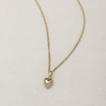 Mini Heart Necklace | 14K Gold Symbol of Love | Ruby Star Studio

META DESCRIPTION

A miniature heart necklace handcrafted in 14K gold. A timeless symbol of love, connection, compassion and emotional strength. Fine jewelry by Ruby Star Studio.

MINI HEART NECKLACE

A timeless symbol of love, carried close to the heart.

The Mini Heart Necklace is handcrafted in solid 14K gold and designed as a modern heirloom for everyday wear. Delicate in scale yet rich in meaning, this miniature heart pendant celebrates t