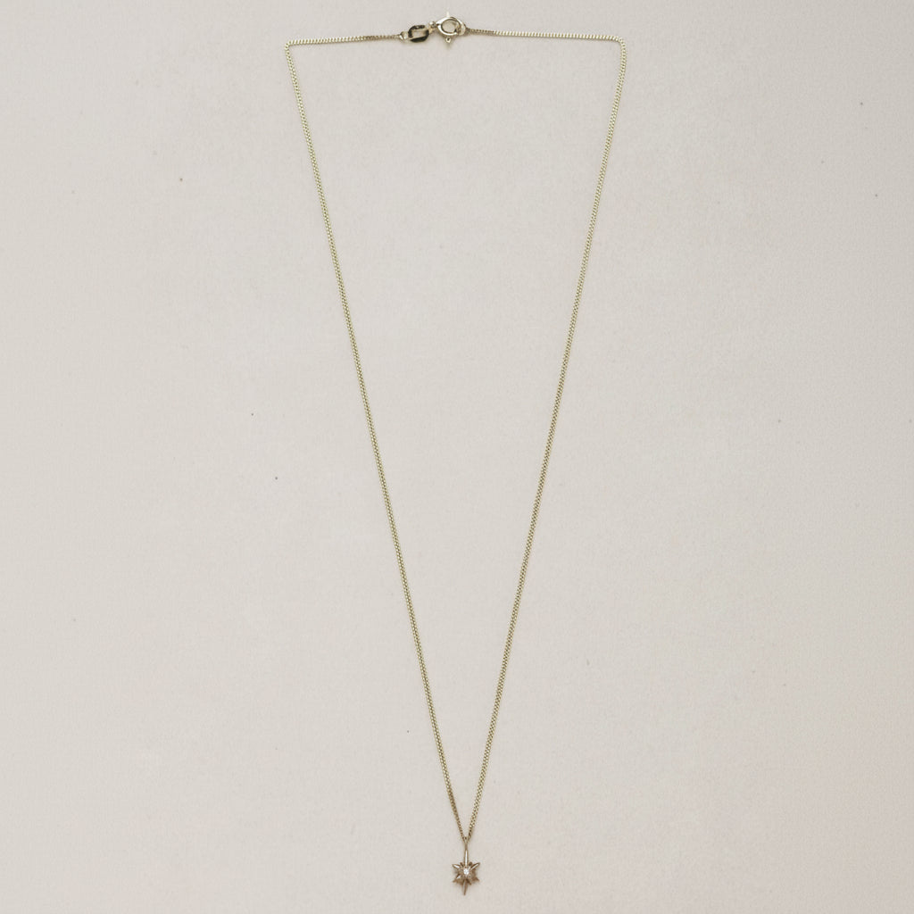 SEO TITLE

Mini Star Necklace – 14K Gold North Star Necklace | Ruby Star Studio

META TITLE

Mini Star Necklace | 14K Gold Guiding Star Necklace | Ruby Star Studio

META DESCRIPTION

A miniature North Star necklace handcrafted in 14K gold. A symbol of direction, purpose and guidance, available with a white diamond, black diamond or ruby.

MINI STAR NECKLACE

A guiding light, worn close to the heart.

The Mini Star Necklace is handcrafted in solid 14K gold and inspired by the North Star — the celestial landm
