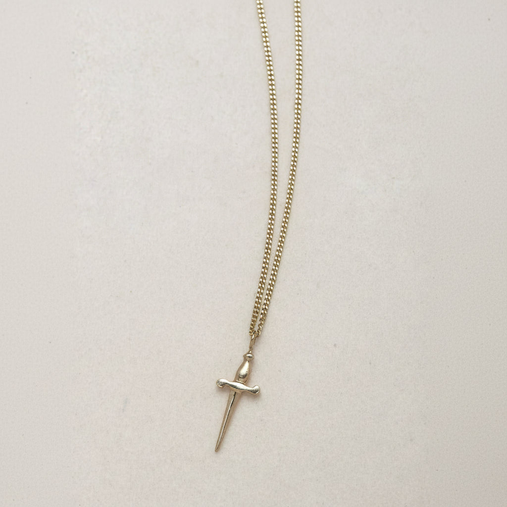 SEO TITLE

Mini Sword Necklace – 14K Gold Protection & Manifestation Necklace | Ruby Star Studio

META TITLE

Mini Sword Necklace | 14K Gold Sword Pendant Necklace | Ruby Star Studio

META DESCRIPTION

A miniature sword necklace handcrafted in 14K gold. A symbol of courage, protection, clarity and manifestation. A powerful modern talisman by Ruby Star Studio.

MINI SWORD NECKLACE

A symbol of courage, clarity and inner strength.

The Mini Sword Necklace is handcrafted in solid 14K gold and designed as a min