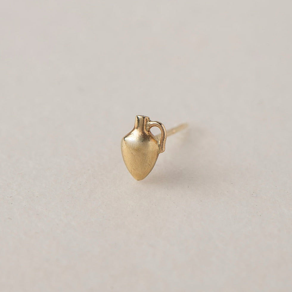 A miniature 14K gold vase stud earring symbolizing femininity, creation, nurturing and sacred energy. Handcrafted fine jewelry by Ruby Star Studio.

MINI VASE STUD

A vessel of creation, intuition and feminine strength.

The Mini Vase Stud is a delicate symbolic earring handcrafted in solid 14K gold. Inspired by the ancient vessel, this miniature sculptural form represents the power to hold, nurture and transform. Small in scale yet rich in meaning, it is designed for everyday wear and effortless layering.
