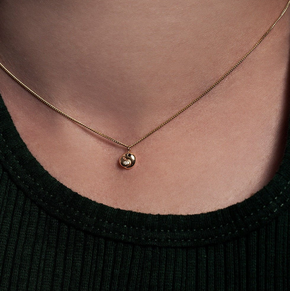 SEO TITLE

Mini Yin Yang Necklace – 14K Gold Yin Yang Necklace with Black & White Diamonds | Ruby Star Studio

META TITLE

Mini Yin Yang Necklace | 14K Gold Balance & Harmony Necklace | Ruby Star Studio

META DESCRIPTION

A miniature Yin Yang necklace handcrafted in 14K gold with black and white diamonds. A symbol of balance, harmony, love and the union of opposites.

MINI YIN YANG NECKLACE

A reminder that wholeness is found in embracing both sides of ourselves.

The Mini Yin Yang Necklace is handcrafted i