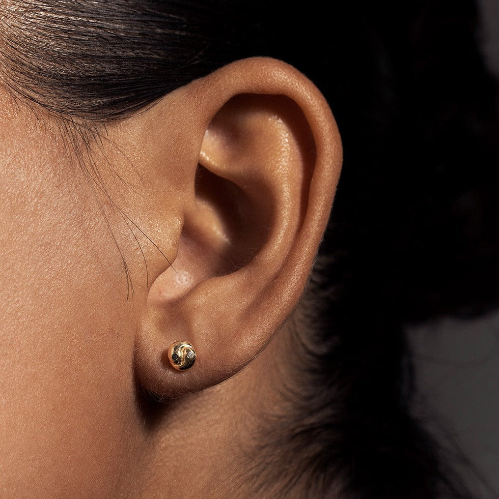 SEO TITLE

Mini Yin Yang Stud – 14K Gold Yin Yang Earring with Black & White Diamonds | Ruby Star Studio

META TITLE

Mini Yin Yang Stud | 14K Gold Balance & Harmony Earring | Ruby Star Studio

META DESCRIPTION

A miniature Yin Yang stud handcrafted in 14K gold with black and white diamonds. A symbol of balance, harmony and the union of complementary forces.

MINI YIN YANG STUD

A tiny symbol with a powerful message.

The Mini Yin Yang Stud is handcrafted in solid 14K gold and set with a white diamond and b