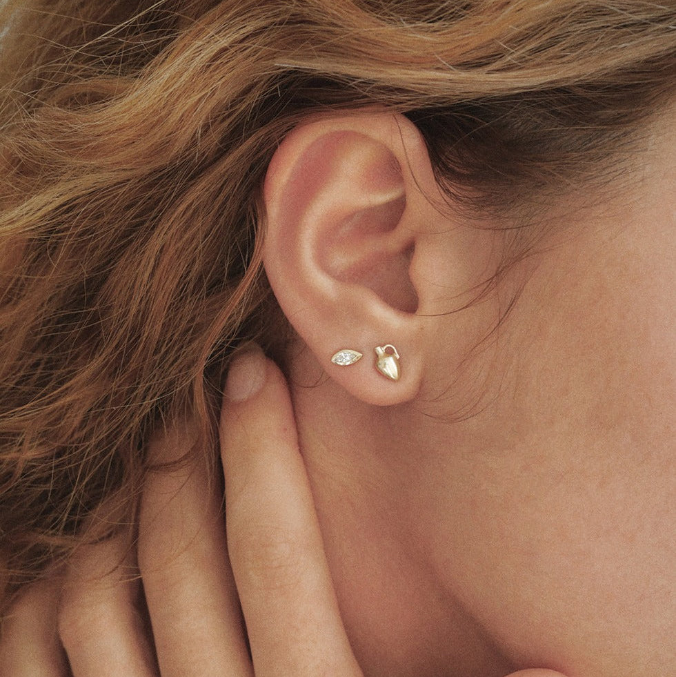 A miniature 14K gold vase stud earring symbolizing femininity, creation, nurturing and sacred energy. Handcrafted fine jewelry by Ruby Star Studio.

MINI VASE STUD

A vessel of creation, intuition and feminine strength.

The Mini Vase Stud is a delicate symbolic earring handcrafted in solid 14K gold. Inspired by the ancient vessel, this miniature sculptural form represents the power to hold, nurture and transform. Small in scale yet rich in meaning, it is designed for everyday wear and effortless layering.

